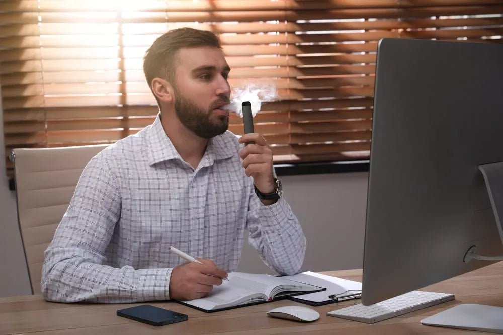 Man using Delta 8 disposable vape