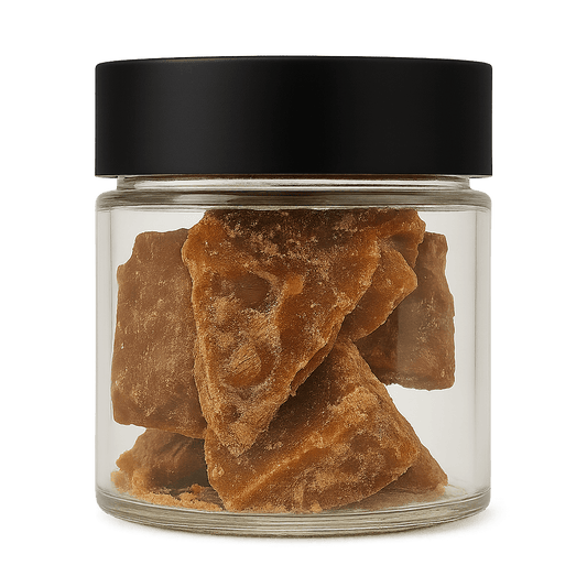 Glass jar with black lid containing crystalized CBG distillate